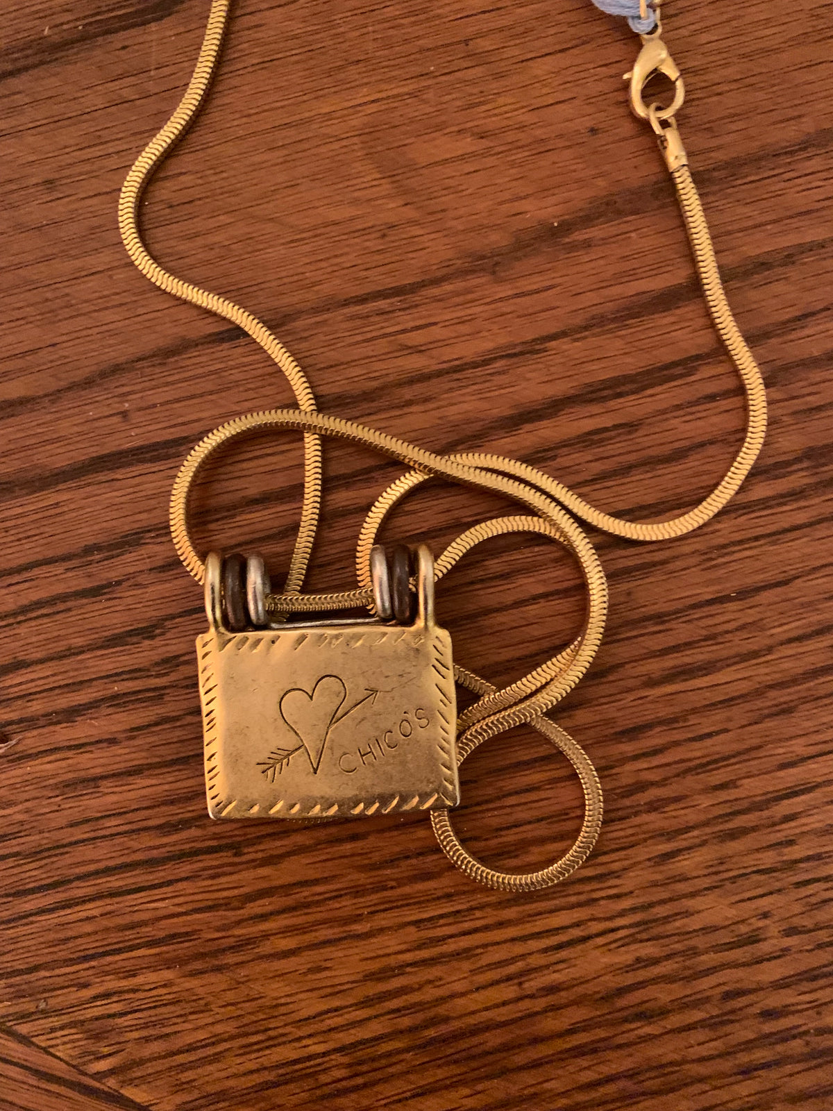Chico’s mixed-metal "Generations of Love" folding book/locket pendant necklace.