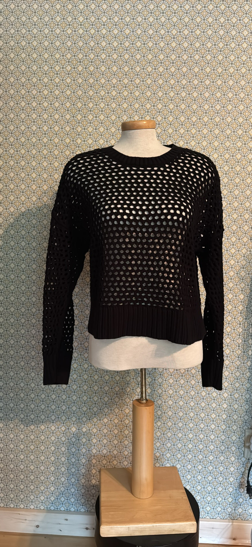 A black open-knit long-sleeve sweater 