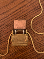 Chico’s mixed-metal "Generations of Love" folding book/locket pendant necklace.