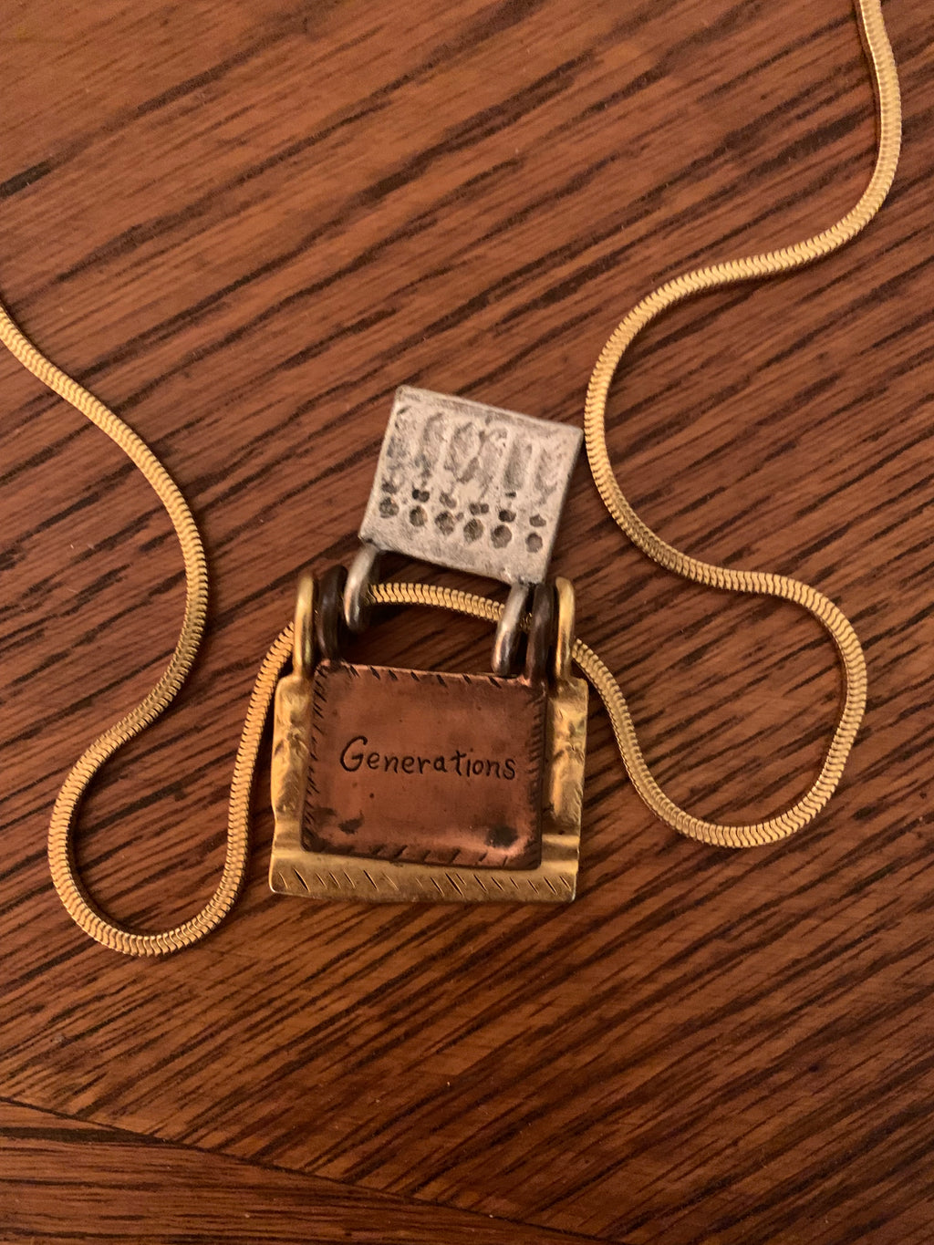 Chico’s mixed-metal "Generations of Love" folding book/locket pendant necklace.