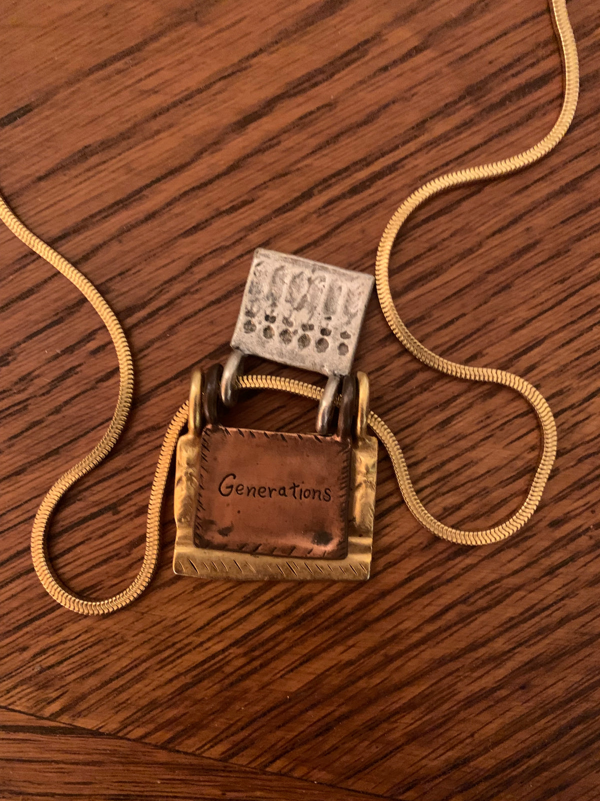 Chico’s mixed-metal "Generations of Love" folding book/locket pendant necklace.