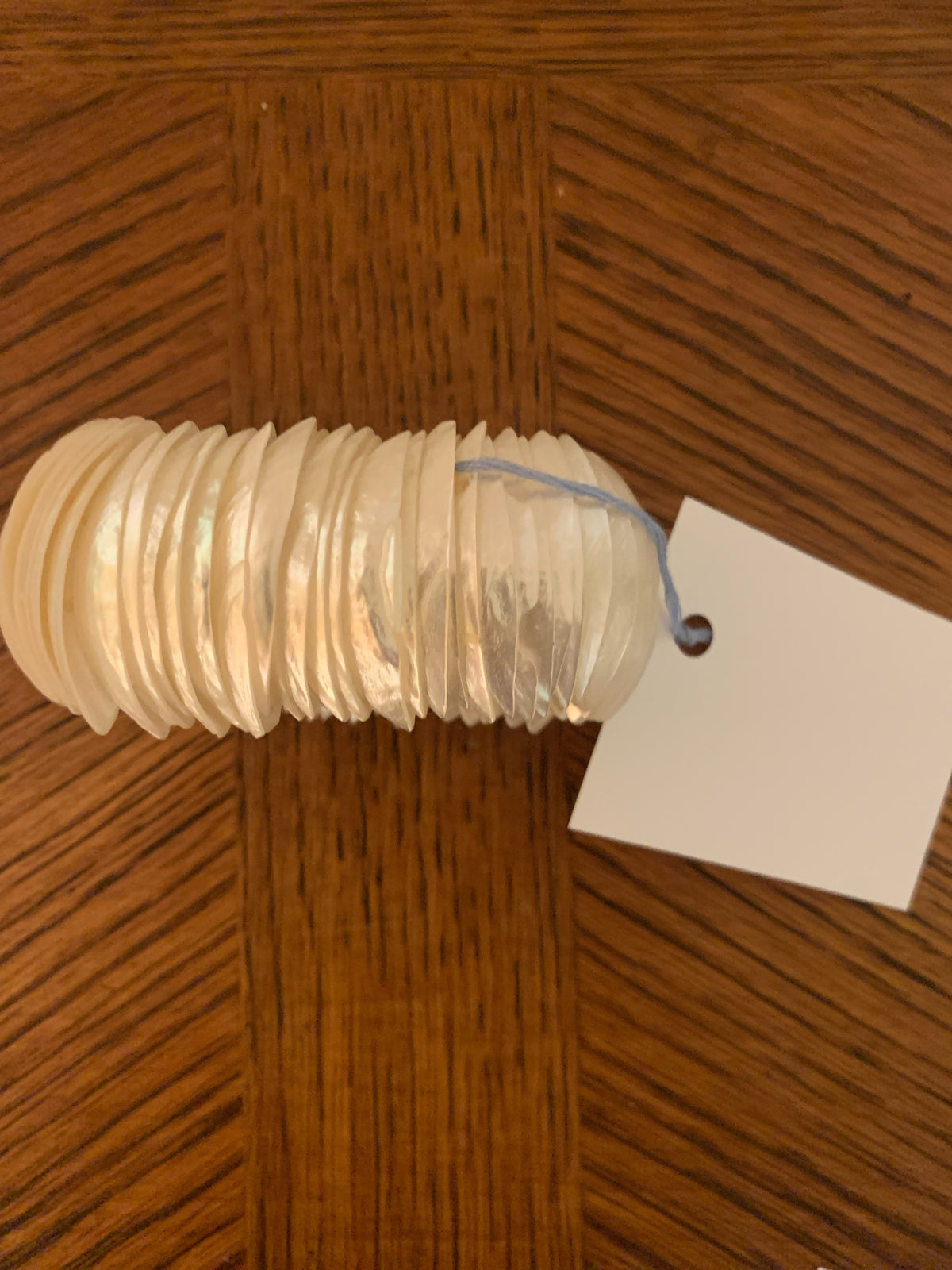 This vintage-inspired elastic stretch bracelet layers delicate mother-of-pearl or Capiz shell slices into a luminous, iridescent design that catches light with every movement
