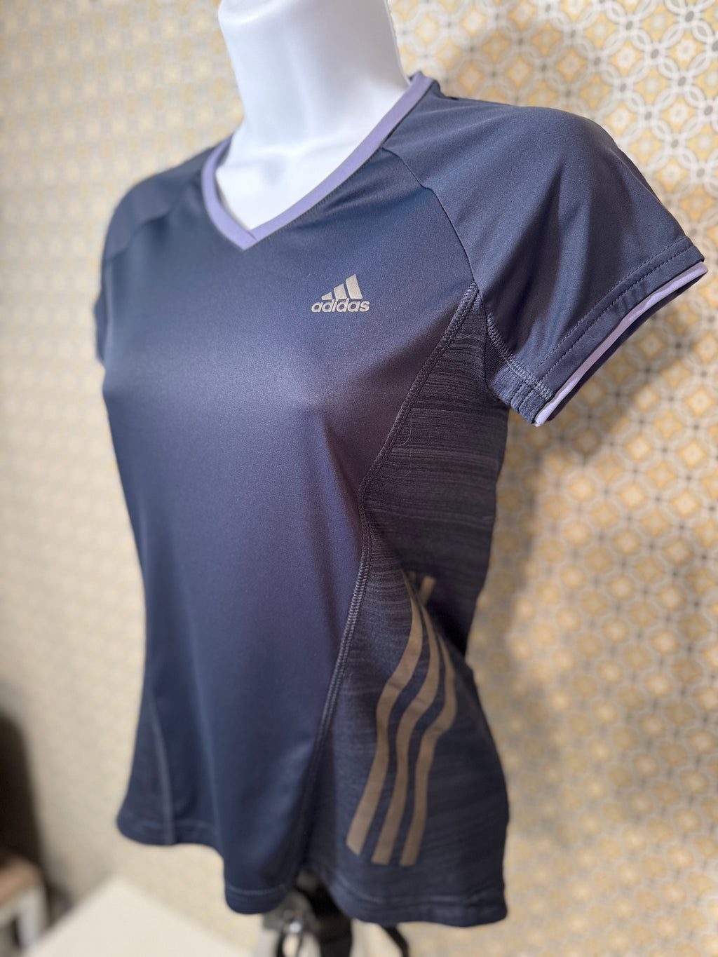 Navy blue, short sleeve, v-neck Adidas active wear women's fit top in extra small for sale by consignment.  