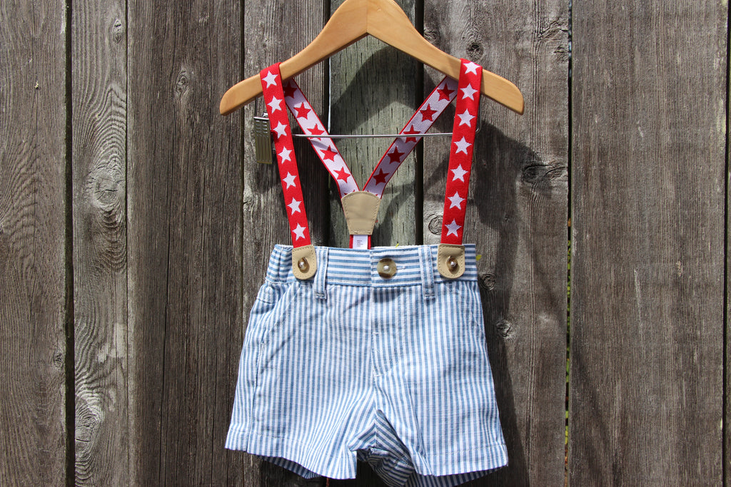 A pair of baby boy's shorts with red and white star-patterned suspenders 