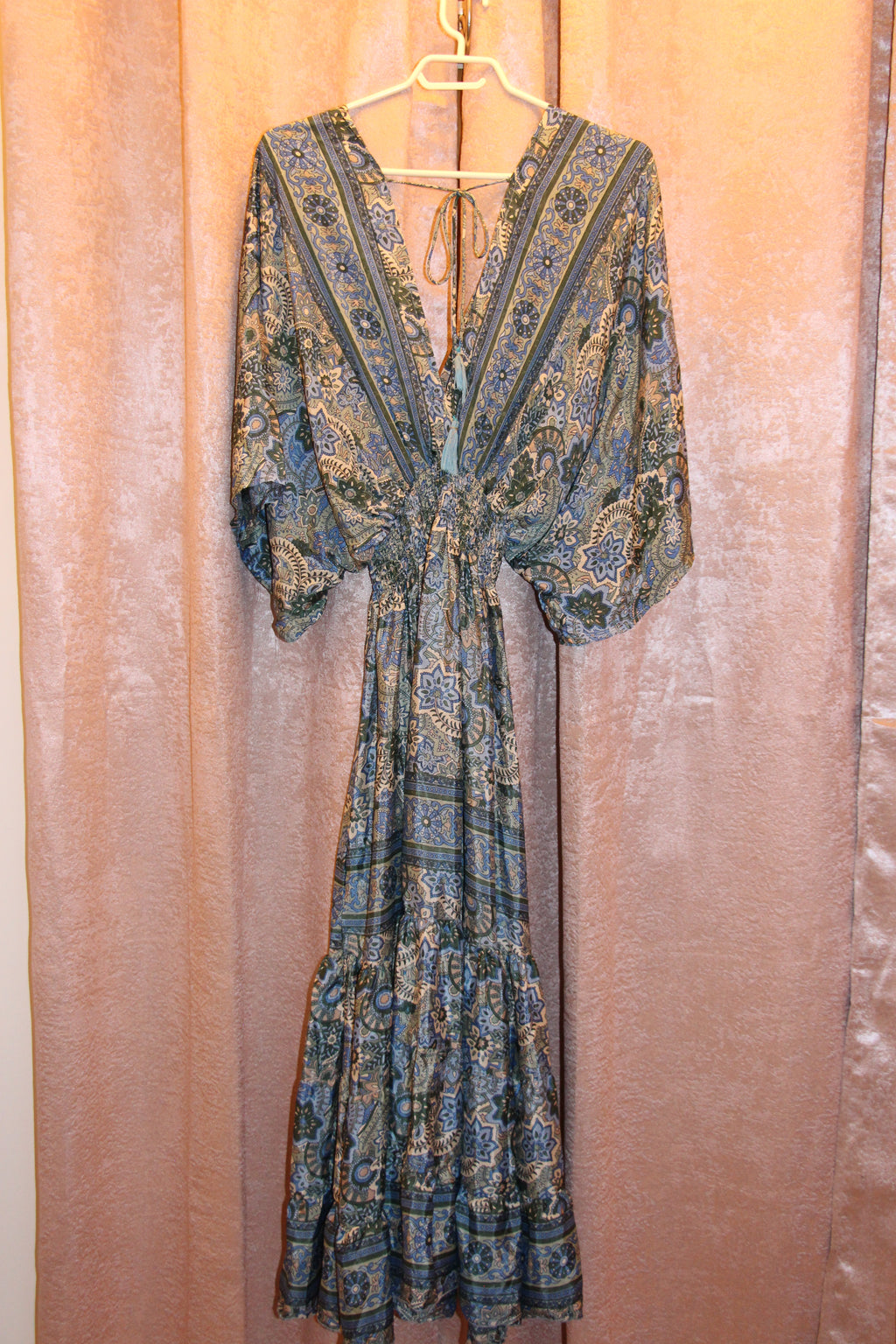 A consignment boutique  long-sleeve maxi dress with a blue, green, and beige paisley pattern, by Bold and Beautiful  this Art Silk Roper Dress  has elasticized shirring. 