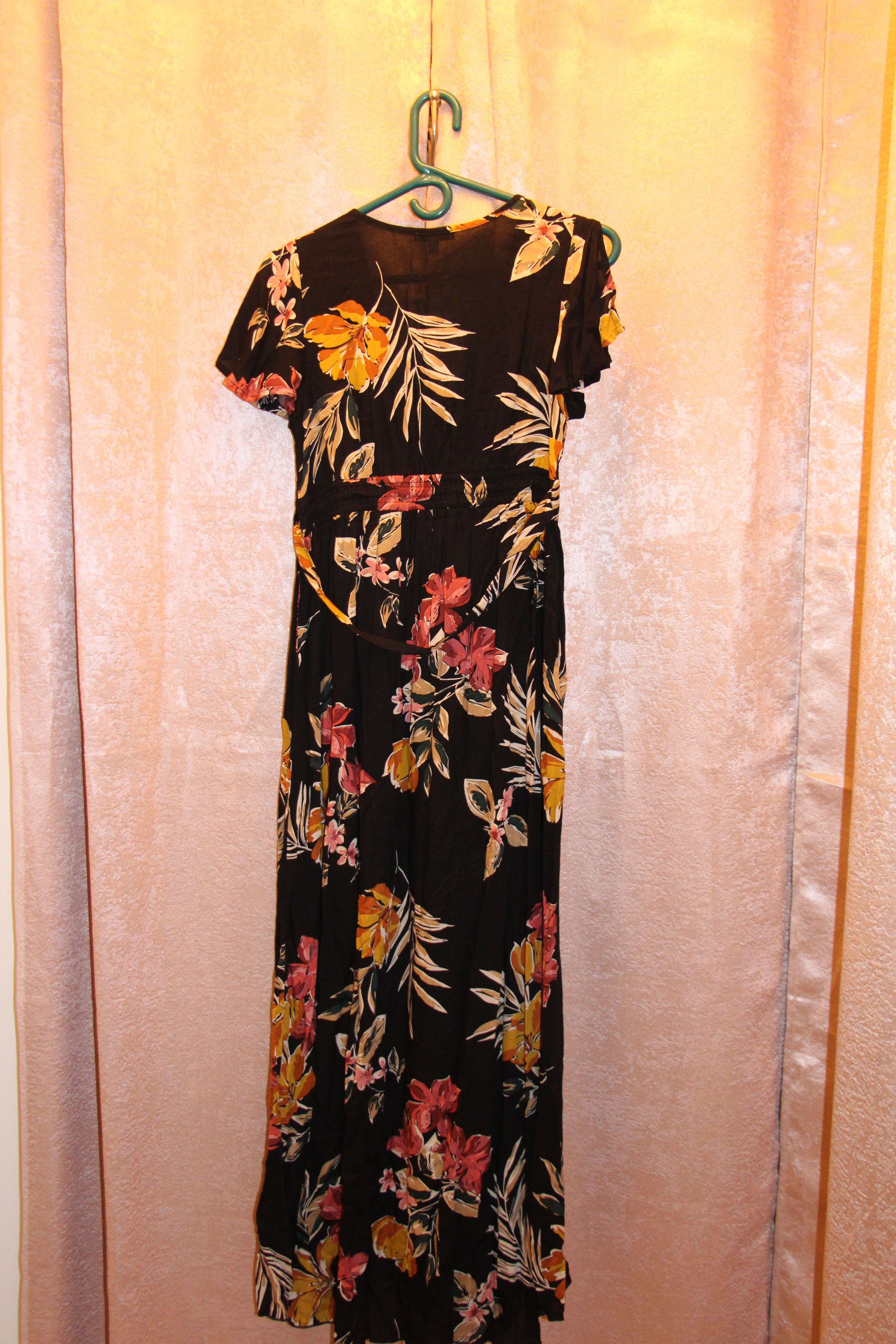 A consignment boutique black maxi dress with a vibrant floral print in pink, yellow, and orange, NWT Size S Patrons of Peace Black Floral Short Sleeve Maxi Dress.