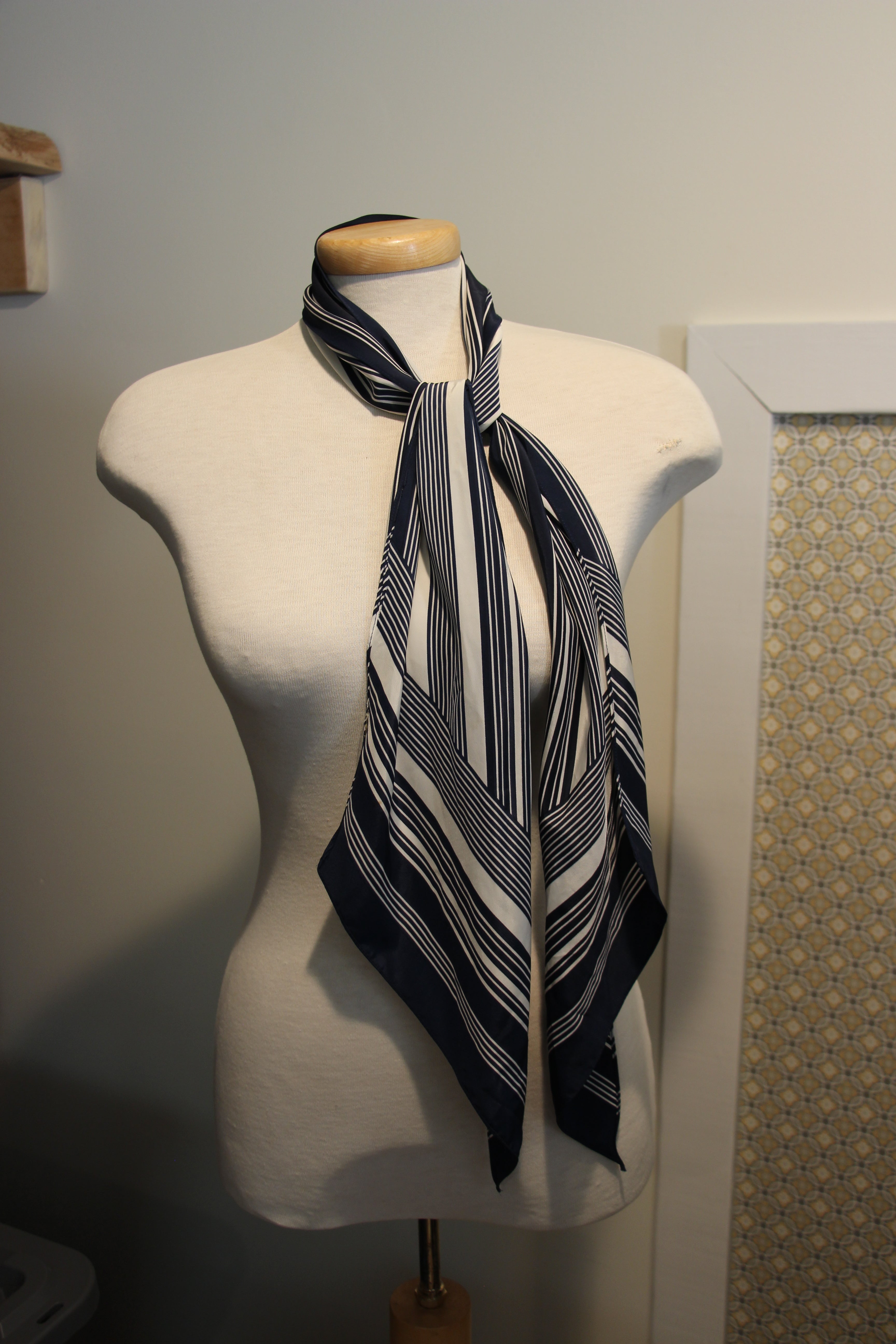A consignment navy blue and white striped scarf.