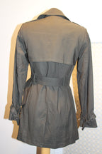 A dark green trench coat displayed on a mannequin from the back, featuring a waist belt and long sleeves on consignment.