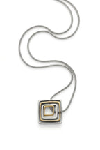 Striking geometric modernist pendant from the 1970s–80s era. Tilted concentric square frames in mixed metal tones—silver, gold, and antiqued finishes create dynamic visual depth.