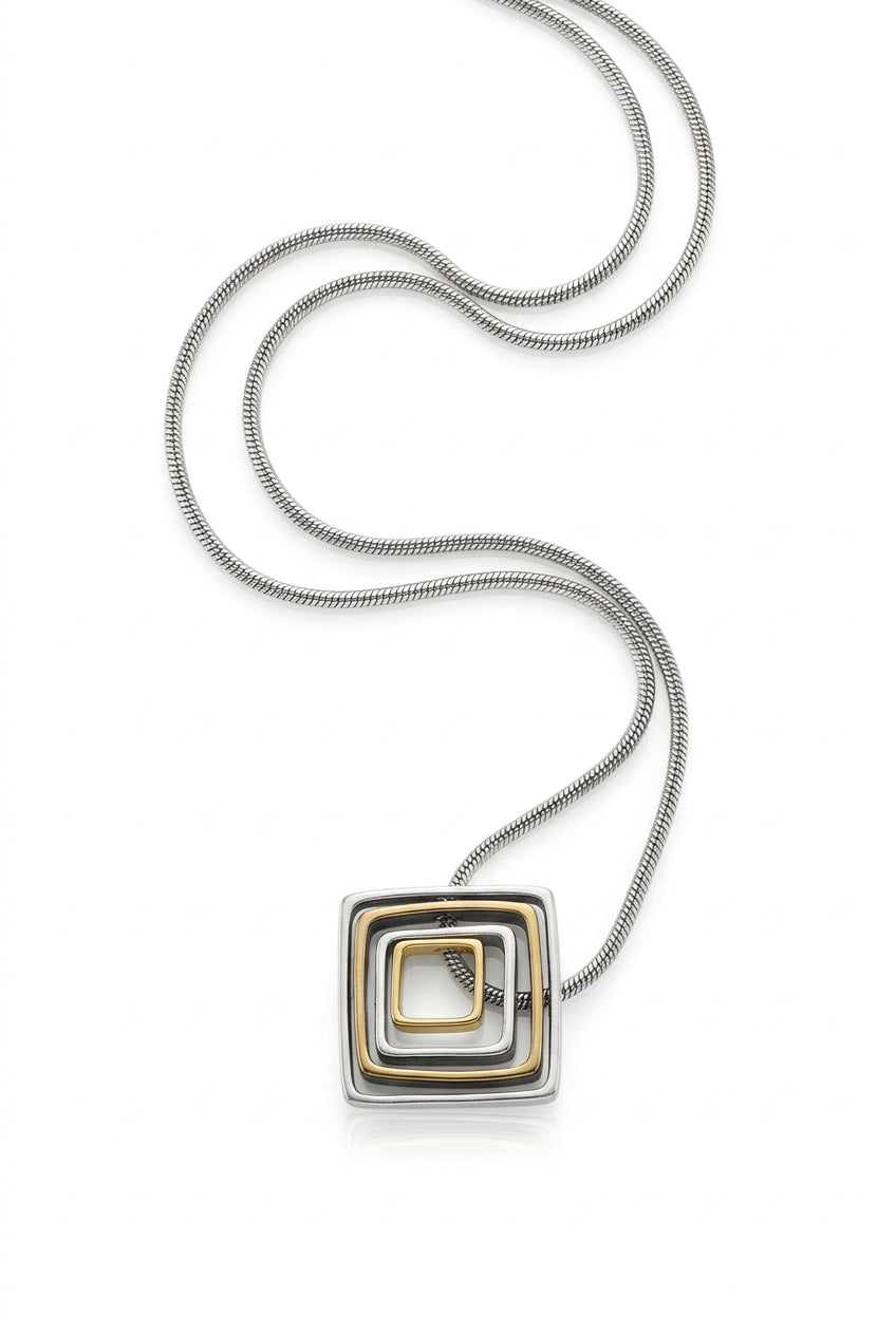 Striking geometric modernist pendant from the 1970s–80s era. Tilted concentric square frames in mixed metal tones—silver, gold, and antiqued finishes create dynamic visual depth.