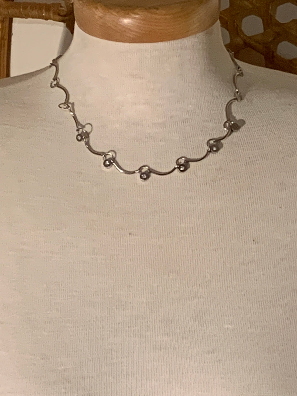 wavy station choker-style necklace features delicate silver-tone links adorned with faux diamond accents