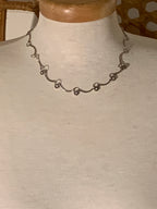wavy station choker-style necklace features delicate silver-tone links adorned with faux diamond accents