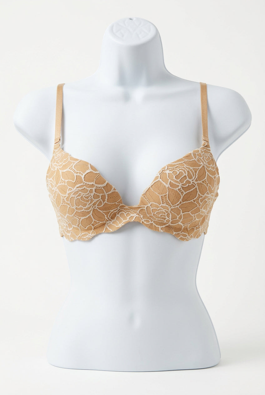 Beige lace bra on a mannequin on consignment.